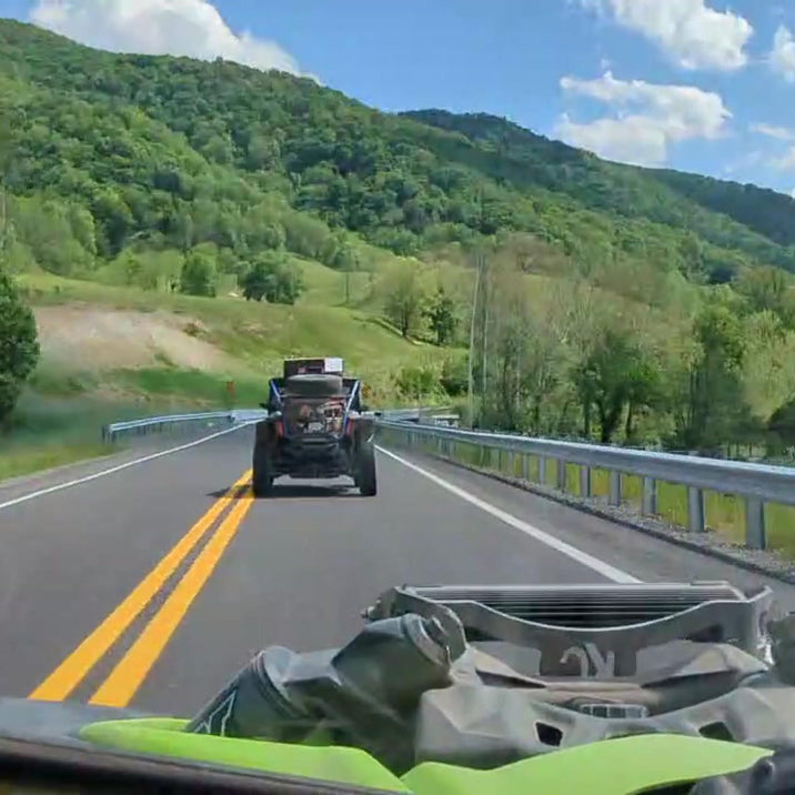 Discovery SXS quadricycle on a paved mountain road
